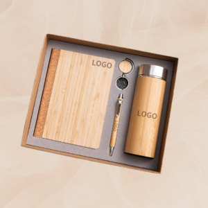 Custom laser-engraved bamboo corporate gift set with notebook, tumbler, pen, and keychain in a craft box